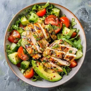 Healthy avocado chicken salad served in a bowl with fresh ingredients