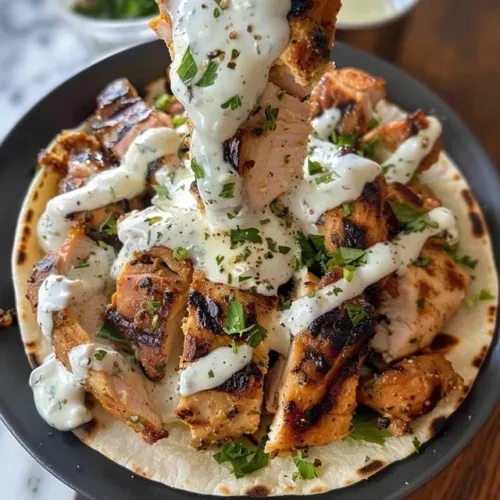 Delicious chicken shawarma with creamy garlic sauce on a plate