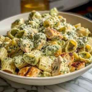 Creamy pesto chicken pasta bake with fresh basil and cheese