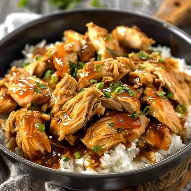 Crockpot Honey Garlic Chicken served on a plate with rice and vegetables