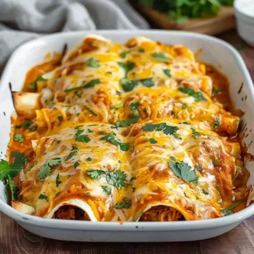 High protein enchiladas topped with fresh ingredients and served on a plate.