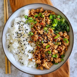 Healthy sesame ground chicken dish served in a bowl with vegetables.