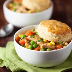 Bowl of easy slow cooker chicken pot pie soup garnished with parsley.