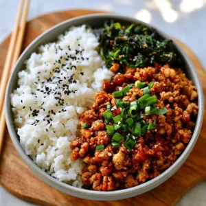 Healthy ground chicken meal prep bowls with colorful vegetables and grains