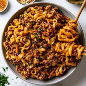 Sticky honey garlic chicken noodles dish garnished with green onions