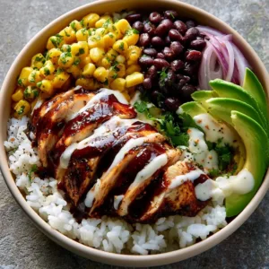 Delicious BBQ chicken rice bowl topped with fresh ingredients and sauce