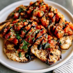 Plate of delicious grilled chicken bruschetta topped with fresh tomatoes and basil