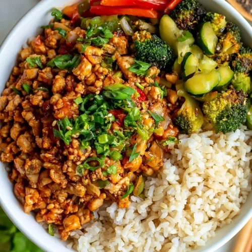 Delicious Firecracker Ground Chicken Bowl garnished with fresh vegetables